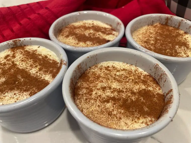 Rice Pudding garnished with powdered cinnamon in light blue cups.