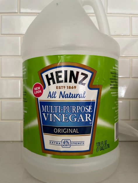 A bottle of Heinz vinegar on a kitchen counter.