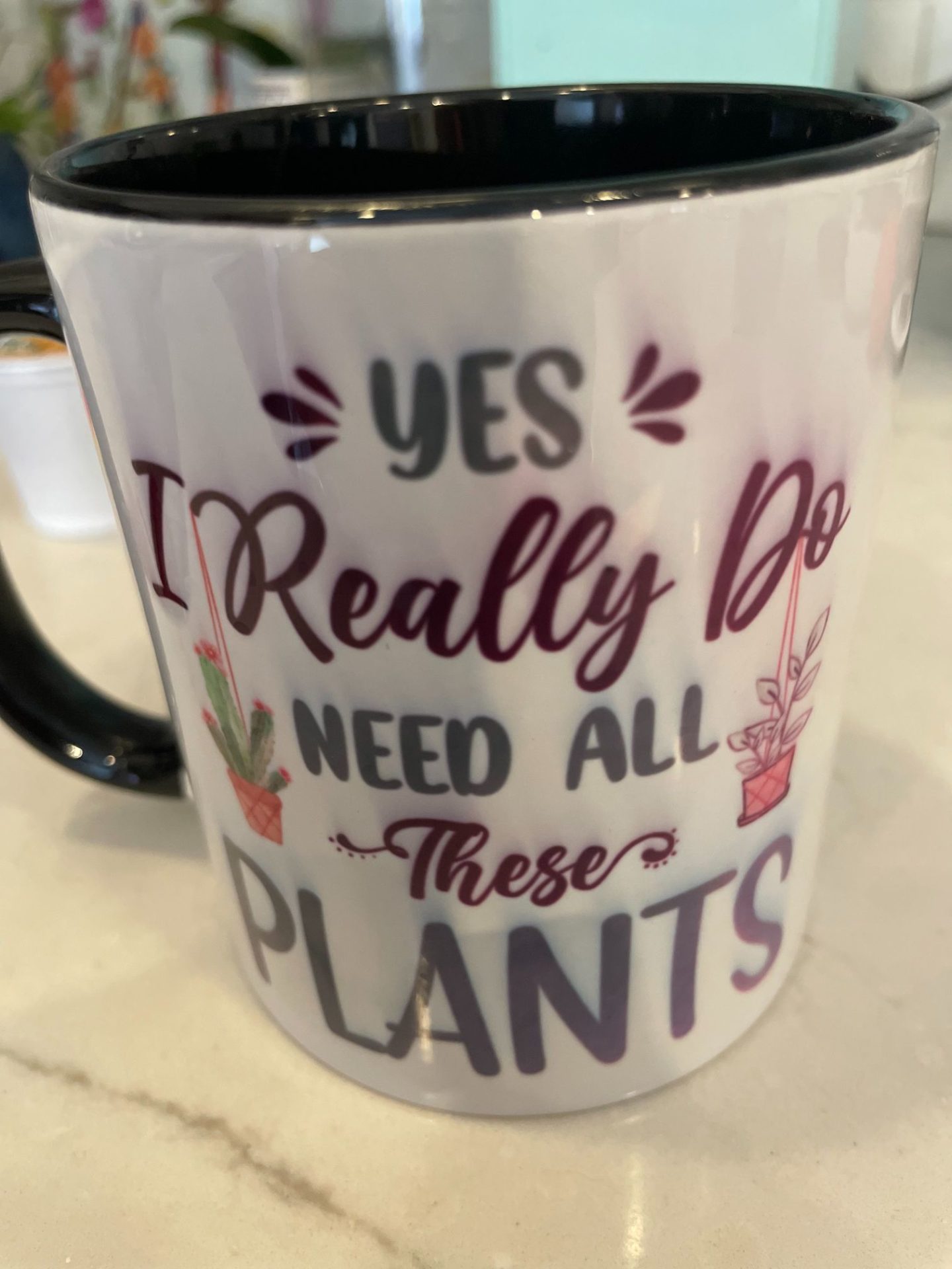 A coffee mug with the title, Yes I really need all these plants. Should coffee ground be sprinkled in the garden?